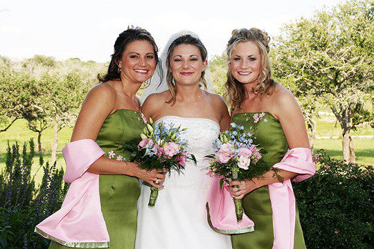 Bride with sisters posing for the camera
