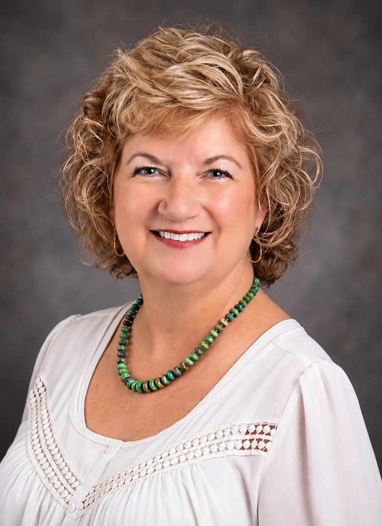 san antonio headshots of woman with curlky hair wearing white shirt with beads
