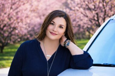 outdoor portrait woman with cherry blooms in the background san antonio