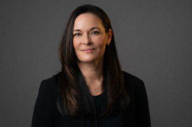 woman headshot wearing black outfit on dark gray background san antonio